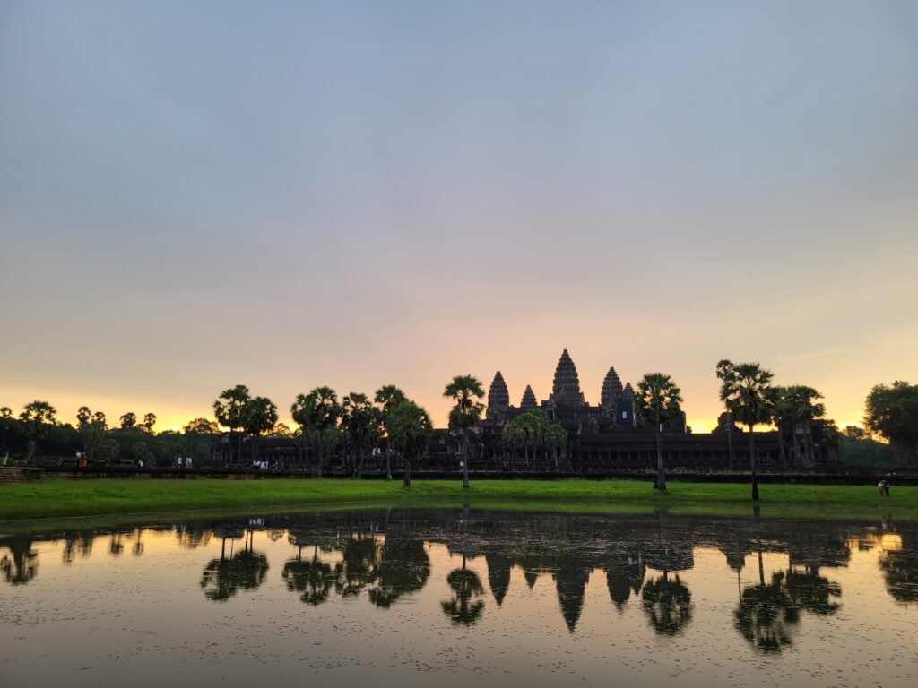Angkor Wat silhouetted at sunrise and reflected in the pond, Siem Reap, Cambodia