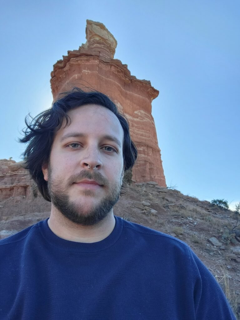Dylan in front of a banded sandstone pillar in Palo Duro Canyon, Texas
